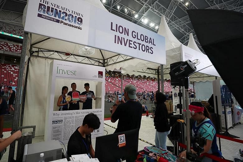Runners getting their snapshots at Lion Global Investors' booth.