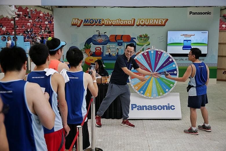 Participants queuing up to spin for prizes at Panasonic's game booth.