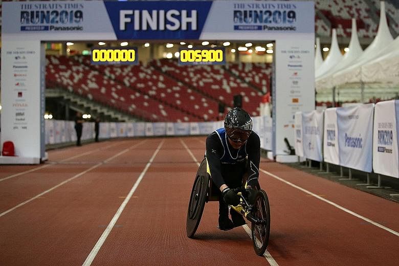 Paralympian wheelchair racer William Tan finishing the 18.45km race yesterday. He was the lone participant in his race and was making his official debut in the ST Run this year. He hopes his participation will encourage fellow wheelchair racers to take pa