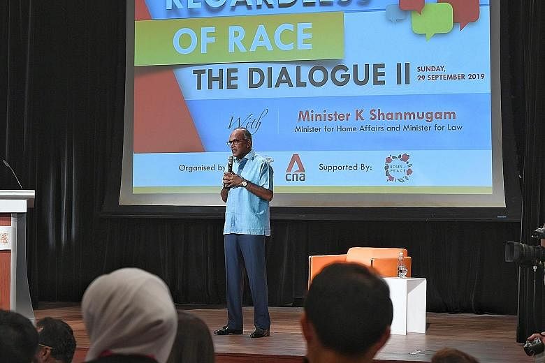 Home Affairs and Law Minister K. Shanmugam addressing the audience at yesterday's dialogue. He fielded questions on issues such as creating safe spaces for open discourse. ST PHOTO: KHALID BABA