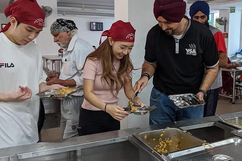 Instagram user Sheena Phua with Mr Sarabjeet Singh, president of the Young Sikh Association, during her visit to the Central Sikh Temple in Towner Road yesterday. She was invited to a gurdwara so she could learn more about Sikh traditions.
