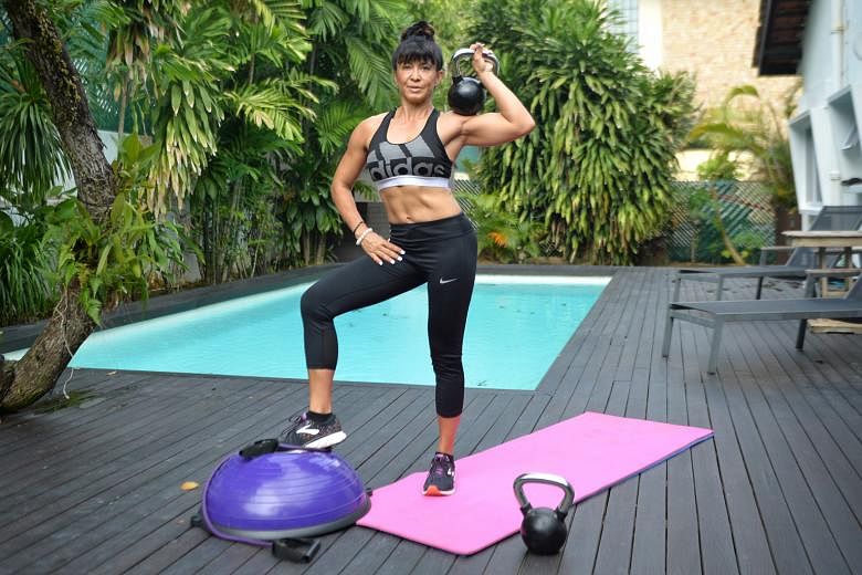 Mrs Sharona Hurmuses, a personal trainer and a mother of three, exercises regularly at home by her pool. 