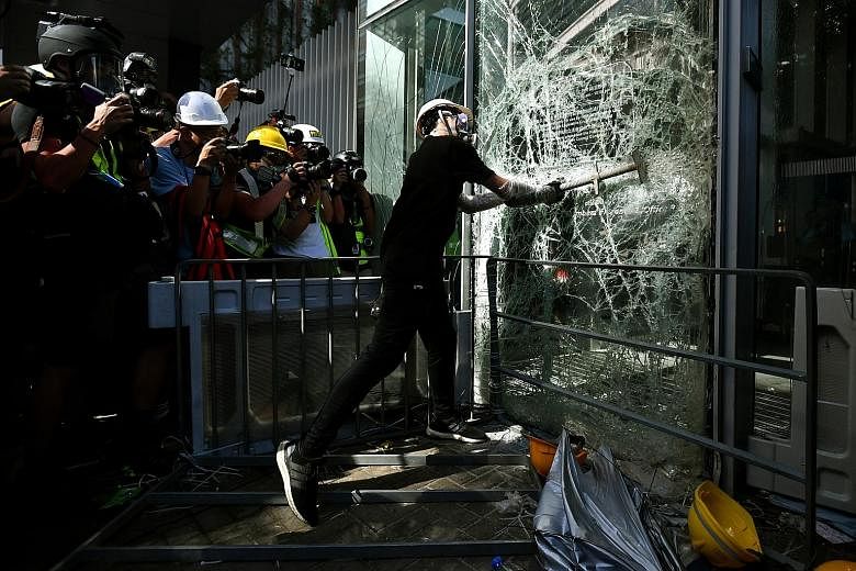 A protester smashing a glass panel at the Legislative Council building in Hong Kong on July 1, the anniversary of the city's handover to Chinese rule. This photo will be among the highlights at the Through The Lens exhibition at the National Museum o
