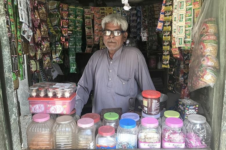 Above: Shopkeeper Moolchand said that over the past two years, his average daily sales have dropped by half. Left: Mr Manu Raghuvanshi, who sells tractors, has seen his sales fall by 25 per cent from last year.