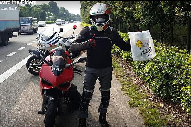 Mr Thomas Varghese with his Ducati motorbike and reward - a tote bag with items including a limited edition FlashPay card - after being stopped by the Traffic Police for being a role model. PHOTOS: USE YOUR ROADSENSE/ FACEBOOK