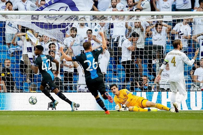 Brugge forward Emmanuel Bonaventure (left) reeling away after scoring the first goal in the Champions League Group A match against Real Madrid at the Santiago Bernabeu on Tuesday. Real recovered to clinch a 2-2 draw.