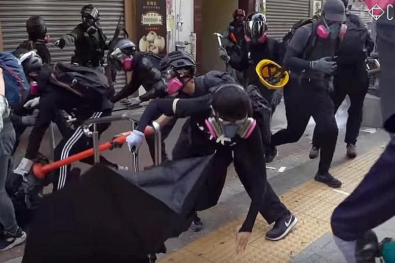Screenshots from a video showing the sequence of events during clashes in Tsuen Wan, Hong Kong, on Tuesday. From top: The 18-year-old protester dressed in black (centre, holding up pole) attacks a police officer. Another officer then shoots the teena