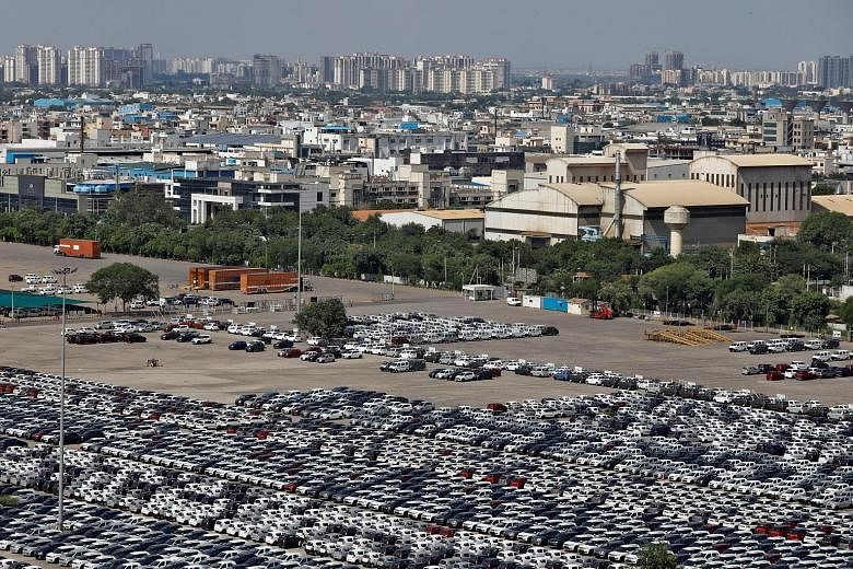 Cars parked at Maruti Suzuki's plant in Manesar, in the northern state of Haryana on Aug 11. The carmaker, which has the biggest market share in India, suffered a whopping 34 per cent drop in sales in August.