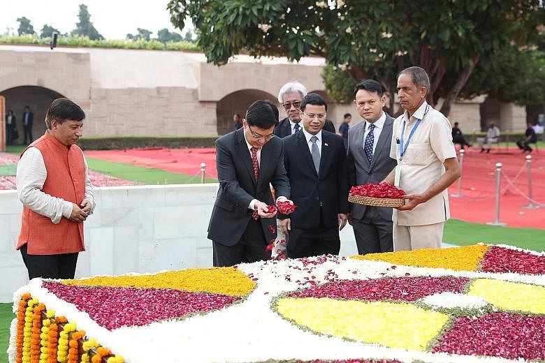 Deputy Prime Minister Heng Swee Keat paying tribute to Mahatma Gandhi at Raj Ghat, Delhi, on Gandhi's 150th birth anniversary. Beside him are Mr Desmond Lee, Minister for Social and Family Development and Second Minister for National Development, and