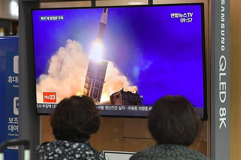 People in Seoul watching file footage yesterday of a North Korean missile launch, the same day the North fired what appeared to be a submarine-launched ballistic missile. Under United Nations Security Council regulations, North Korea is banned from b