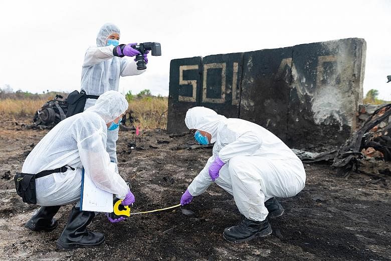 Singapore and Bruneian investigators processing evidence at a "bomb site" during their Solar Wind exercise in Brunei this week. Unlike previous iterations, this year's exercise featured multiple bomb attacks at different locations. PHOTO: SINGAPORE P