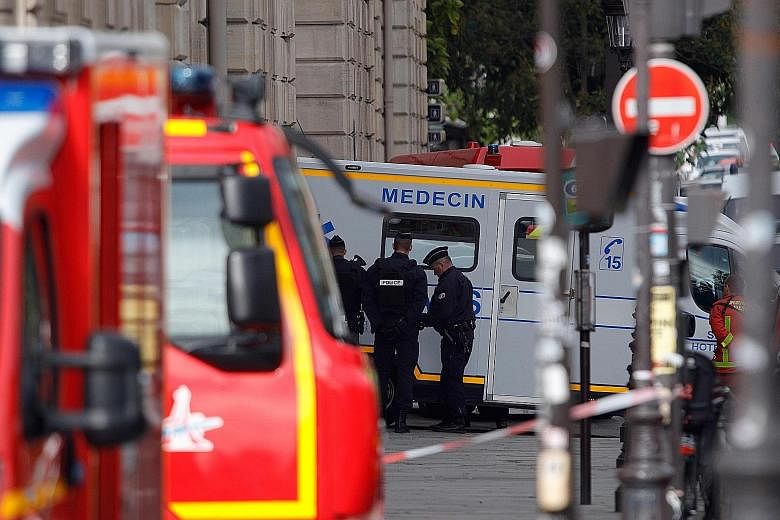 The Paris police headquarters and surrounding premises were cordoned off yesterday after a man stabbed to death four officers before he was shot dead by police. PHOTO: AGENCE FRANCE-PRESSE