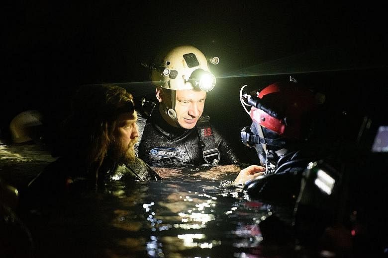 Diver Jim Warny (centre), who joined the mission to rescue a dozen boys and their young football coach in Thailand last year, portrayed himself in the movie The Cave, which will hit Thai cinemas on Nov 28.