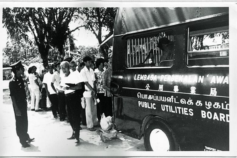 A mobile collection unit from the then Public Utilities Board collecting payment from rural customers in the 1960s for the use of electricity. The PUB's rural electrification programme in the 1960s and 1970s aimed to connect every kampung in Singapor