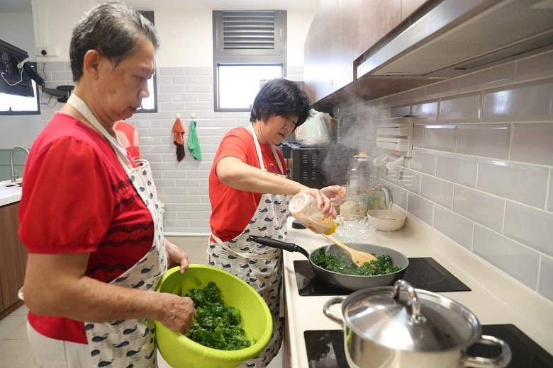 Volunteers cooking at Kampung Admiralty’s active ageing hub. Run by NTUC Health, the hub waives membership fees for participants who volunteer at least three hours a week. 