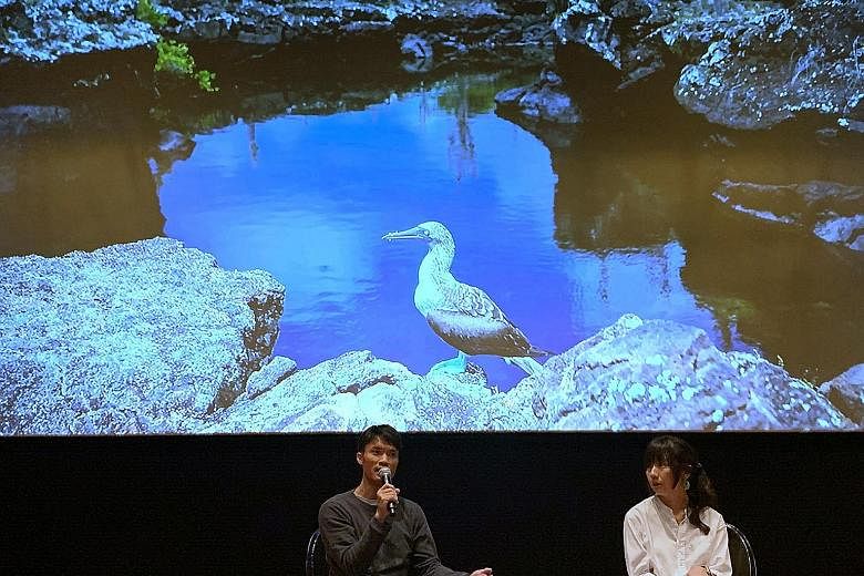ST executive photojournalist Mark Cheong and environment correspondent Audrey Tan giving a talk yesterday on a climate change special published on June 9.