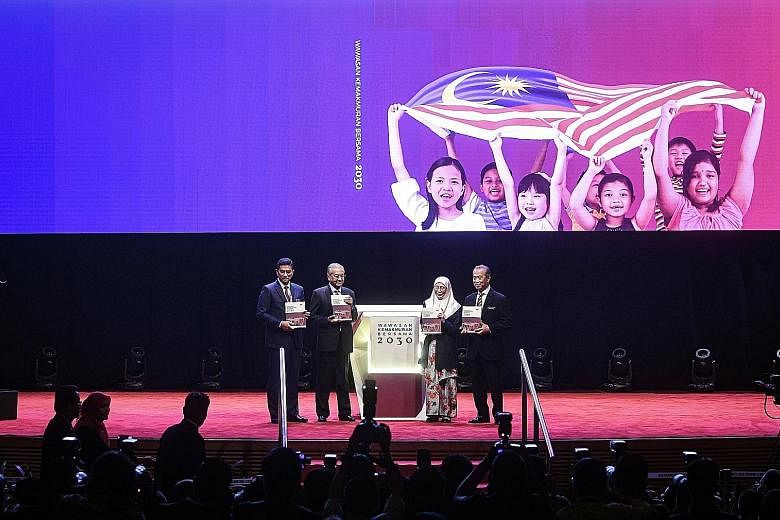 Malaysian Prime Minister Mahathir Mohamad (second from left) at the launch of the Shared Prosperity Vision 2030 plan yesterday. With him are (from left) Economic Affairs Minister Azmin Ali, Deputy Prime Minister Wan Azizah Wan Ismail and Home Ministe
