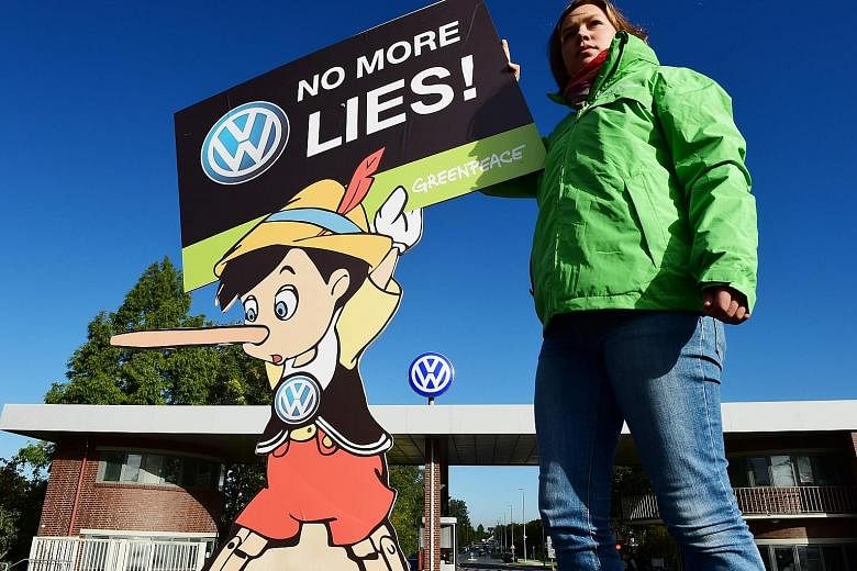 A Greenpeace activist protesting in front of the headquarters of German carmaker Volkswagen in Wolfsburg last month. The auto behemoth has been hit by a scandal involving fraudulent emissions tests of its diesel vehicles. PHOTO: AGENCE FRANCE-PRESSE