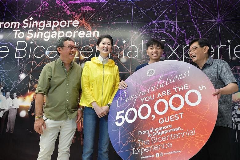 Student Tit Yee Kiat, 18, who is the exhibition's 500,000th visitor, with (from left) Bicentennial Experience creative director Michael Chiang, Singapore Bicentennial Office executive director Gene Tan and Deputy Prime Minister Heng Swee Keat yesterd