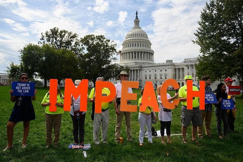 Protesters taking a stand against President Donald Trump in front of the US Capitol building during a "People's Rally for Impeachment" late last month. PHOTO: AGENCE FRANCE-PRESSE