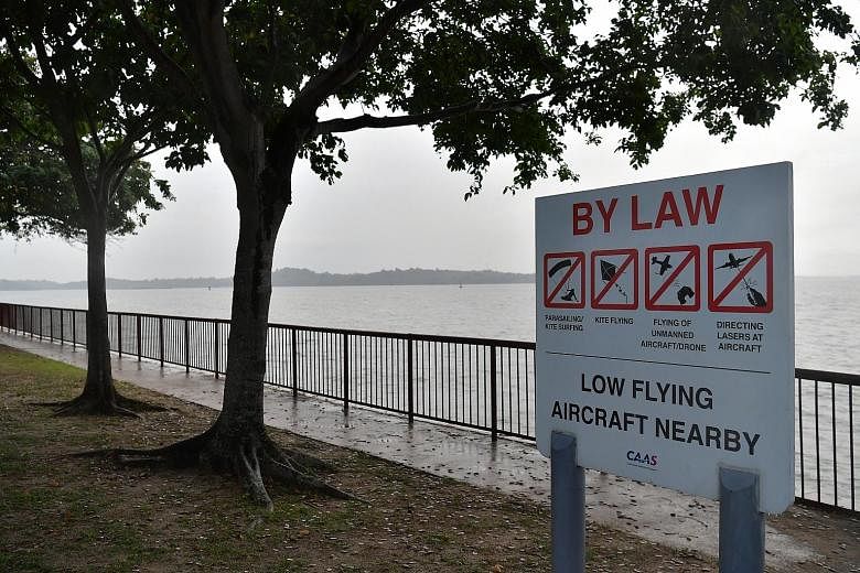 A sign at Changi Beach warning against the flying of drones and other activities that could affect flights at nearby Changi Airport.