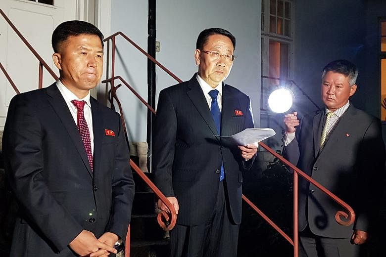 North Korea's top nuclear negotiator Kim Myong Gil (centre) reading a statement in front of the country's embassy in Stockholm after a meeting with US officials for formal working-level nuclear talks.
