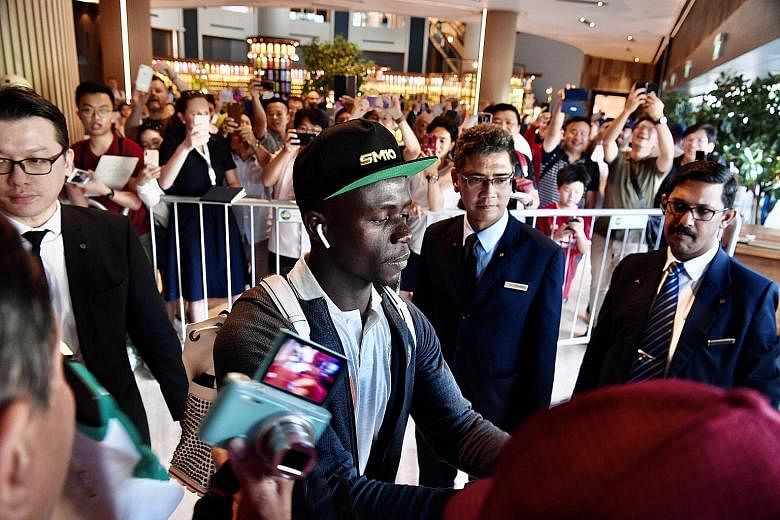 Sadio Mane signing autographs for his supporters, who thronged the lobby of Swissotel The Stamford for the arrival of the Liverpool forward, as well as the Senegal team.