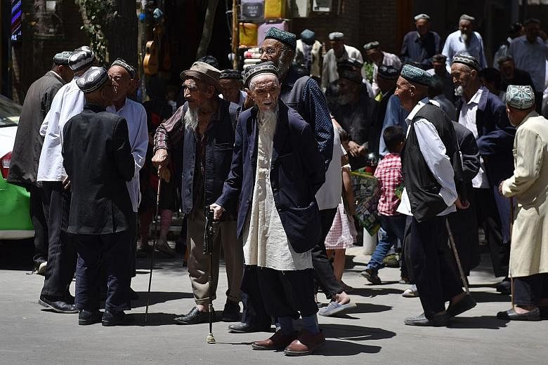 Uighur men leaving a mosque after prayers in Hotan, China's Xinjiang region, in May. The US State Department said the restriction was being imposed on Chinese government leaders and Communist Party officials found responsible for or complicit in the 