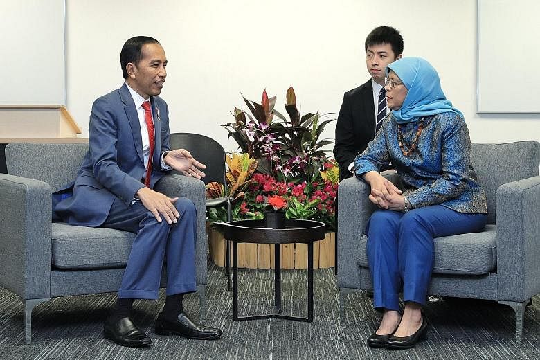 President Halimah Yacob meeting her Indonesian counterpart Joko Widodo at the Singapore University of Social Sciences yesterday. In a Facebook post, Madam Halimah said she congratulated Mr Joko on his son's graduation and entrepreneurship award, and 
