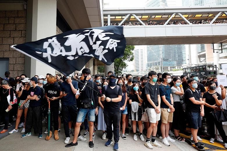 Supporters of an activist outside the High Court in Hong Kong yesterday. The flag reads, "Liberate Hong Kong, revolution of our times". PHOTO: REUTERS