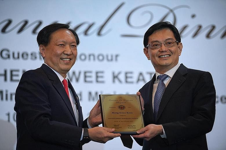 Deputy Prime Minister Heng Swee Keat being conferred the title of The Institution of Engineers, Singapore Distinguished Honorary Patron by IES president Yeoh Lean Weng yesterday.