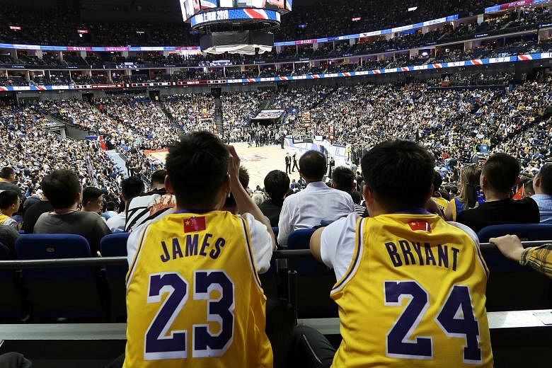 An NBA fan in a Lebron James jersey and another in a Kobe Bryant jersey at yesterday's match between the Los Angeles Lakers and the Brooklyn Nets at the Mercedes-Benz Arena in Shanghai. Controversy over a tweet by an NBA team manager backing anti-Chi