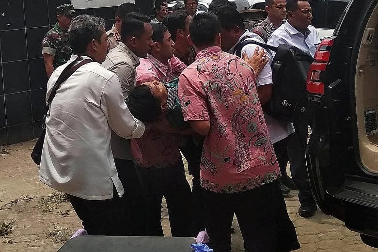 Indonesia's chief security minister Wiranto being carried from a car to the emergency room yesterday after he was attacked in Pandeglang, on Java Island. He was treated for two knife wounds in his stomach. PHOTO: REUTERS
