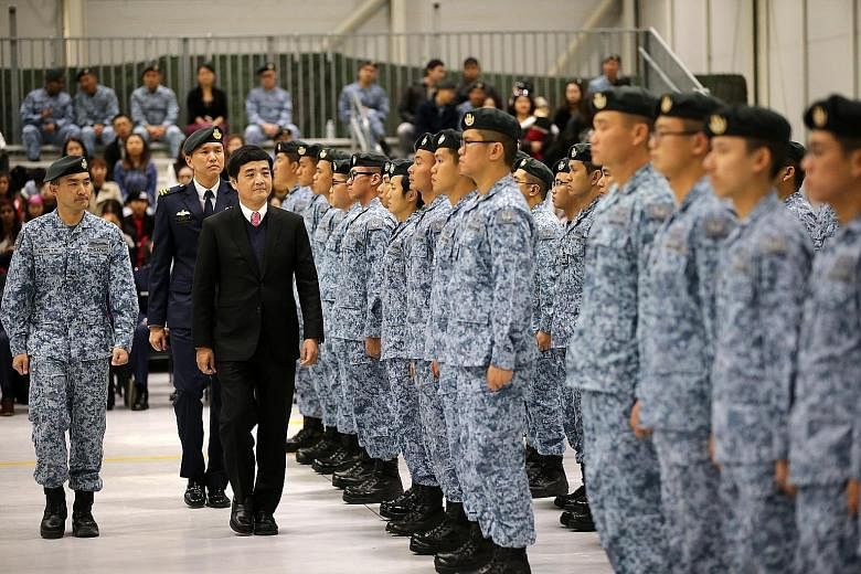 Senior Minister of State for Defence Mr Heng Chee How inspecting the Peace Carvin V parade at Mountain Home Air Force Base in Idaho on Thursday. Behind Mr Heng is Brigadier-General Ho Kum Luen, commander of the RSAF's Air Combat Command.