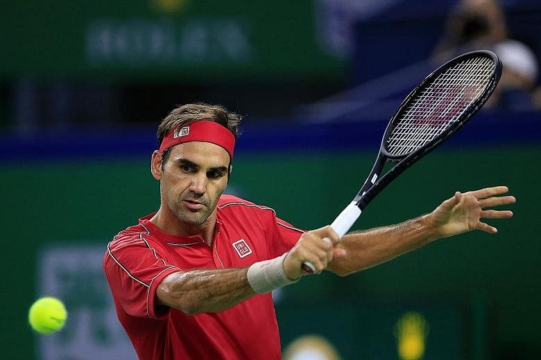 Roger Federer returning to Alexander Zverev of Germany in their Shanghai Masters quarter-final. The Swiss legend lost his cool in the third set after receiving a rare point penalty. PHOTO: REUTERS