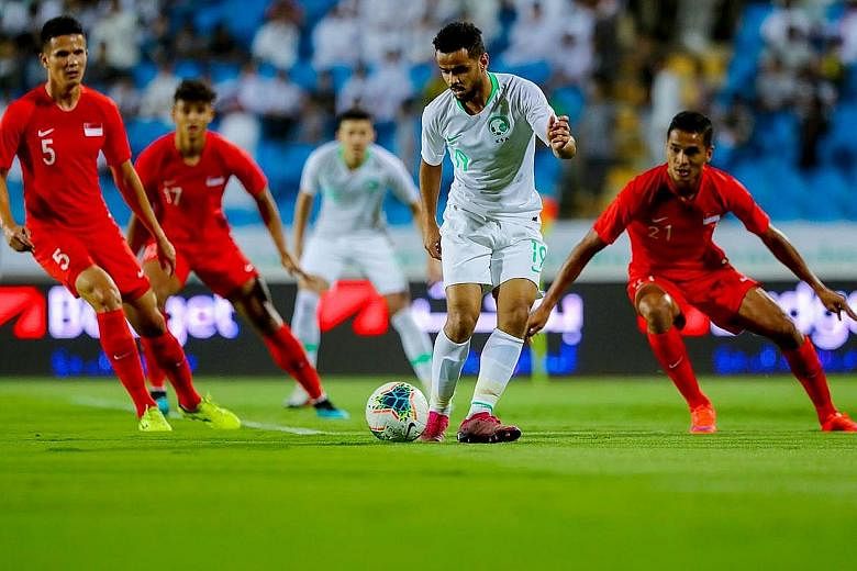 The Singapore defence finding Saudi Arabia forward Abdulfattah Asiri a hard man to contain. He scored a brace in the hosts' 3-0 win in the World Cup qualifier in Buraidah on Thursday night. PHOTO: SAUDI ARABIAN FOOTBALL FEDERATION