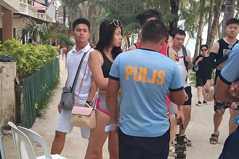 A Taiwanese woman was summoned to the Boracay police station after photos of her wearing a two-piece string bikini along the famous white beach of the island circulated on social media. She was fined 2,500 pesos (S$67). PHOTO: COURTESY OF TRISTAN GEL