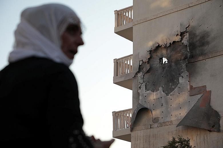 An apartment building in Nusaybin, Turkey, damaged by a rocket fired from Syria on Thursday. Overnight, clashes erupted at different points along the border, with Turkish and Kurdish-led Syrian Democratic Forces (SDF) exchanging shelling, said a spok