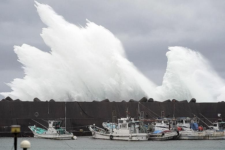 Surging waves generated by Typhoon Hagibis hitting a breakwater at a port in the town of Kiho, Mie prefecture, yesterday. The typhoon is expected to lash central Japan and Tokyo today, affecting transport and major sporting events such as the Rugby W