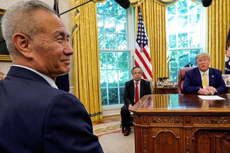 US President Donald Trump spoke to reporters in his Oval Office with Chinese Vice-Premier Liu He (in the foreground) present. Mr Trump said an accord could take four to five weeks to be drafted and could be signed next month. PHOTO: REUTERS