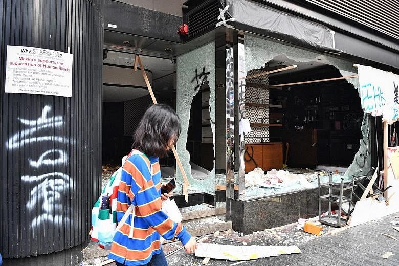 A Starbucks outlet in Kowloon was smashed by protesters yesterday. Protesters have also targeted China banks and shops with perceived links to China. 