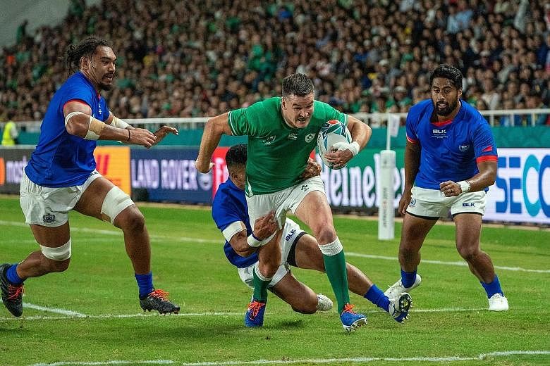 Fly-half Johnny Sexton on his way to scoring one of his two tries which gave Ireland the bonus point in the 47-5 win over Samoa in their Pool A Rugby World Cup clash in Fukuoka yesterday. PHOTO: EPA-EFE