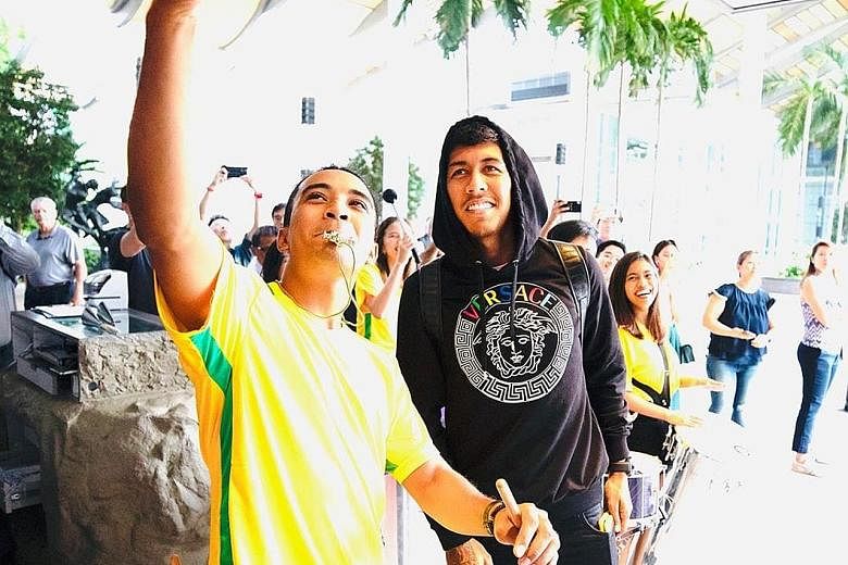 HOT SHOT #1 "Singapore samba" Local percussionist Ahmad Saifullah caught the attention of Liverpool's Roberto Firmino, and a shot with the Brazilian, after his group's loud welcome for the football team. SWEET TWEET "Guess Who? Colleen Rooney edition