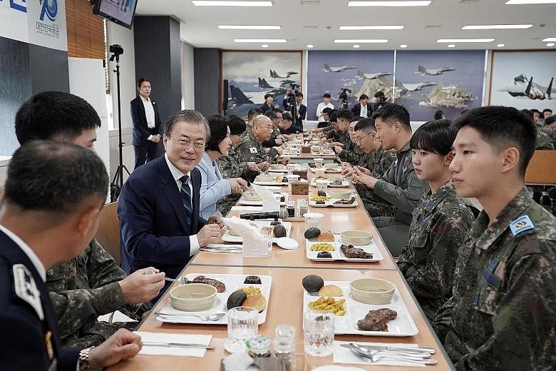 South Korean President Moon Jae-in having lunch with soldiers earlier this month at an air base in Daegu, after attending a ceremony to mark the country's 71st Armed Forces Day. Mr Moon's administration has improved the welfare of national service conscri
