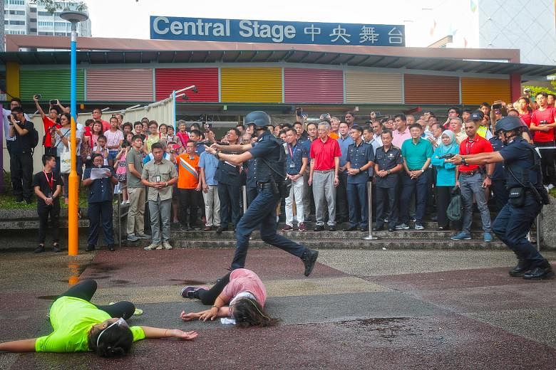 Police officers reacted to a simulated attack by a gunman in Ang Mo Kio yesterday as Prime Minister Lee Hsien Loong, who is an MP for Ang Mo Kio GRC, watched intently along with many other people. Held at Ang Mo Kio Central Stage, the live exercise b