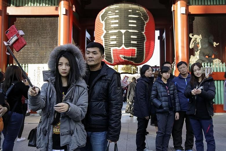 Tourists from China taking wefies in front of a huge paper lantern at the Kaminarimon Gate of Sensoji temple in Asakusa, Tokyo. Chinese nationals made 8.4 million trips to Japan last year, up 13.9 per cent from 2017, according to the Japan National T