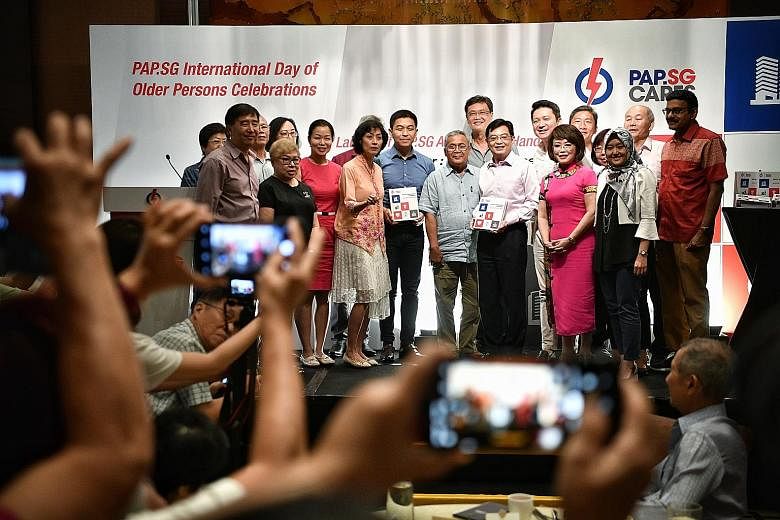 Deputy Prime Minister Heng Swee Keat with the People's Action Party Seniors Group executive committee, which includes Ms Cheng Li Hui, Ms Joan Pereira, Mr Tan Chuan-Jin, Mr Henry Kwek, Dr Lily Neo and Ms Rahayu Mahzam. ST PHOTO: ARIFFIN JAMAR