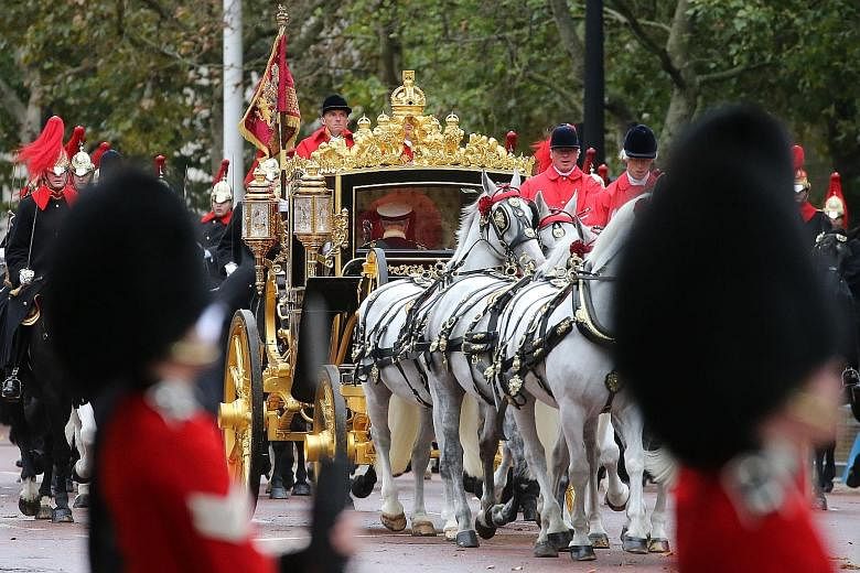 The Queen returning to Buckingham Palace in the Diamond Jubilee State Coach after the opening of Parliament. PHOTO: AGENCE FRANCE-PRESSE Yeoman warders performing a traditional "ceremonial search" in the Prince's Chamber in the House of Lords before 