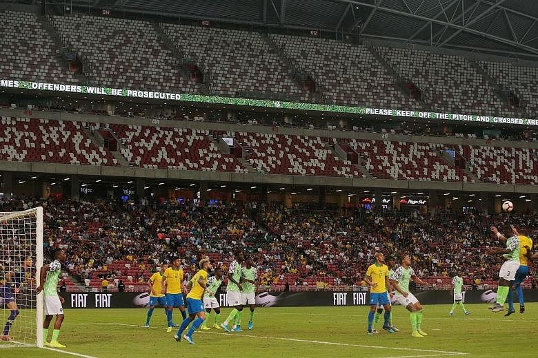 The higher tiers of the 55,000-capacity National Stadium were empty for last Sunday's Brazil v Nigeria friendly game (above) and also last Thursday's Brazil v Senegal match. ST PHOTO: JASON QUAH