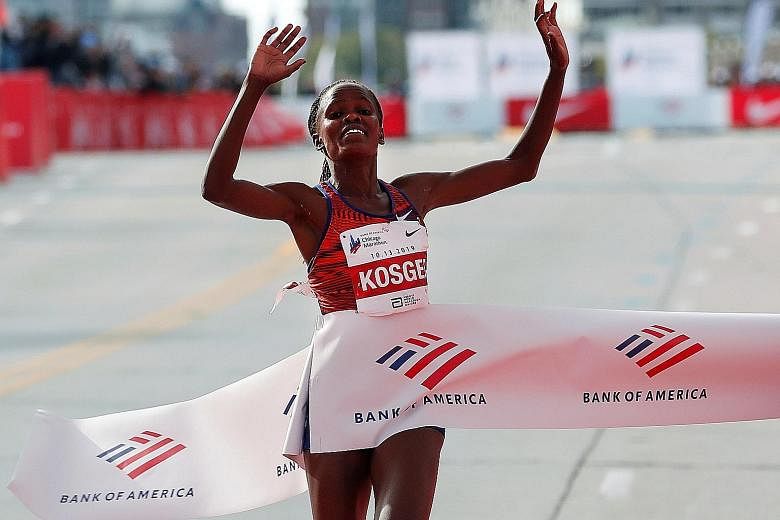 Brigid Kosgei crosses the Chicago Marathon finish line in 2:14:04 to smash Paula Radcliffe's world mark by a whopping 1:21. PHOTO: REUTERS
